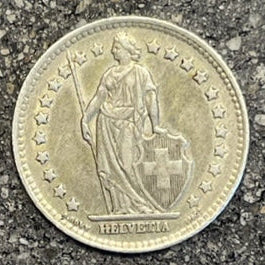 Swiss 1 Franc Silver Coin front on a concrete background. - Mountainstruck Coin Jewelry