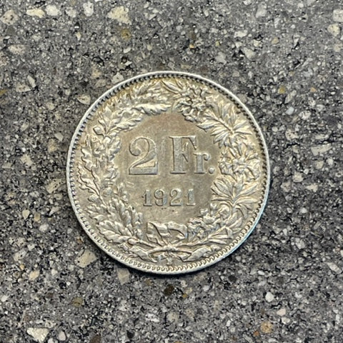 Swiss 2 Franc Silver Coin back on a concrete background. - Mountainstruck Coin Jewelry