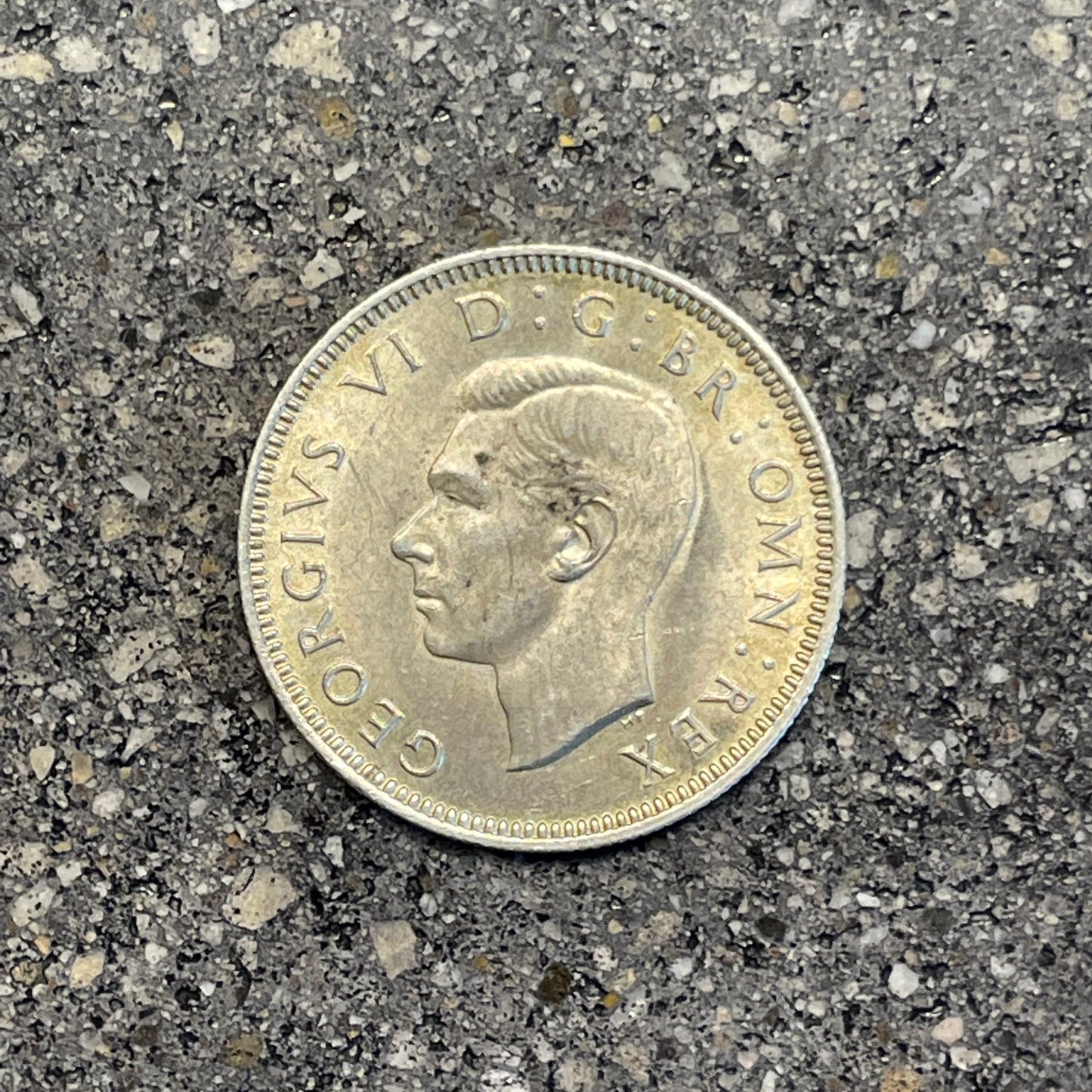 UK One Shilling Silver Coin front on a concrete background. - Mountainstruck Coin Jewelry