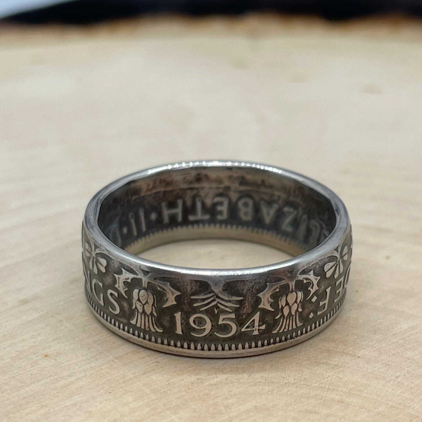 UK Two Shillings Coin Ring on a light wood round. - Mountainstruck Coin Jewelry