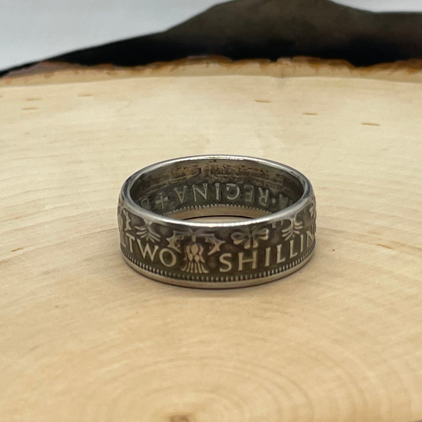 UK Two Shillings Coin Ring on a light wood round. - Mountainstruck Coin Jewelry