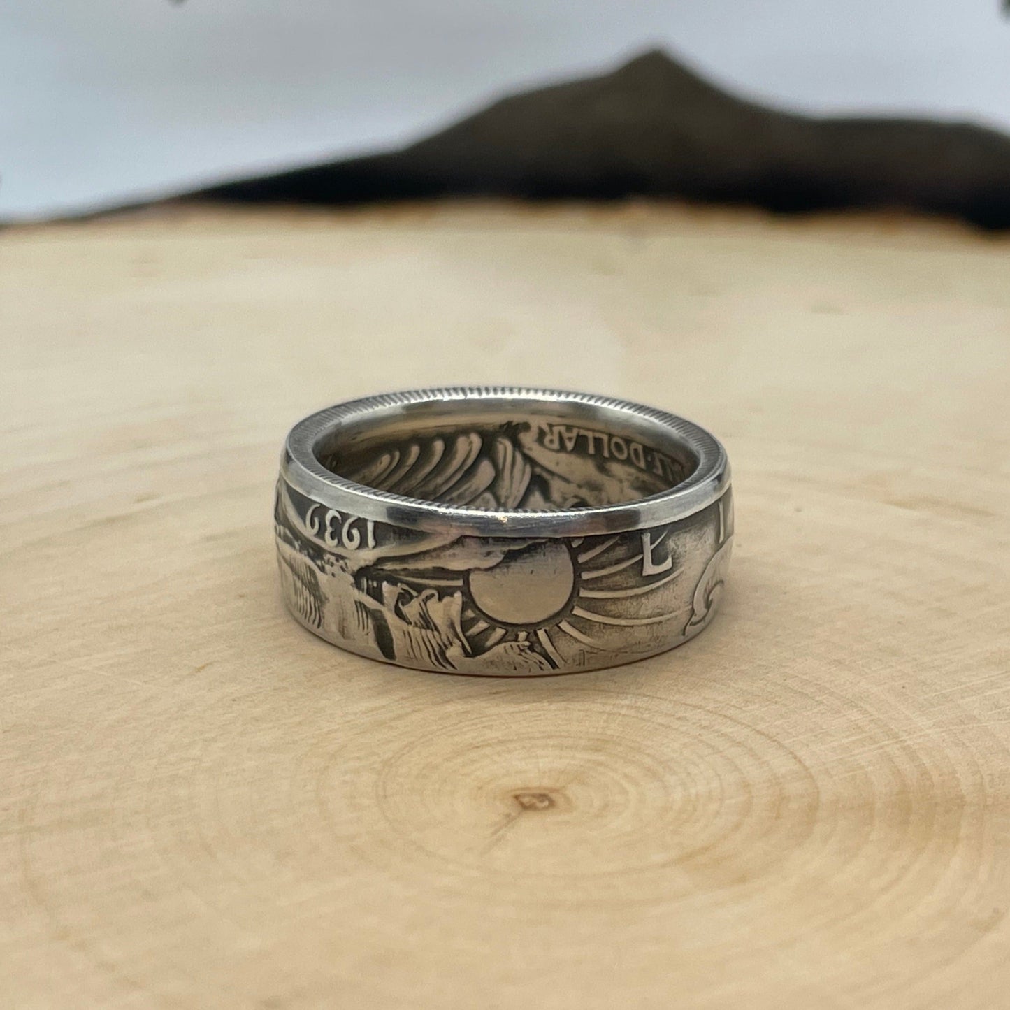 Walking Liberty Silver Half Dollar Coin Ring on a light wood round with a mountain outline in the background. - Mountainstruck Coin Jewelry