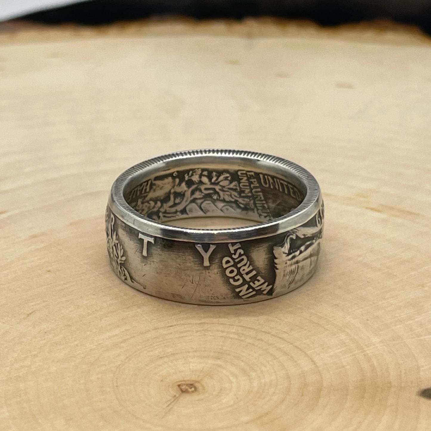 Walking Liberty Silver Half Dollar Coin Ring on a light wood round. - Mountainstruck Coin Jewelry