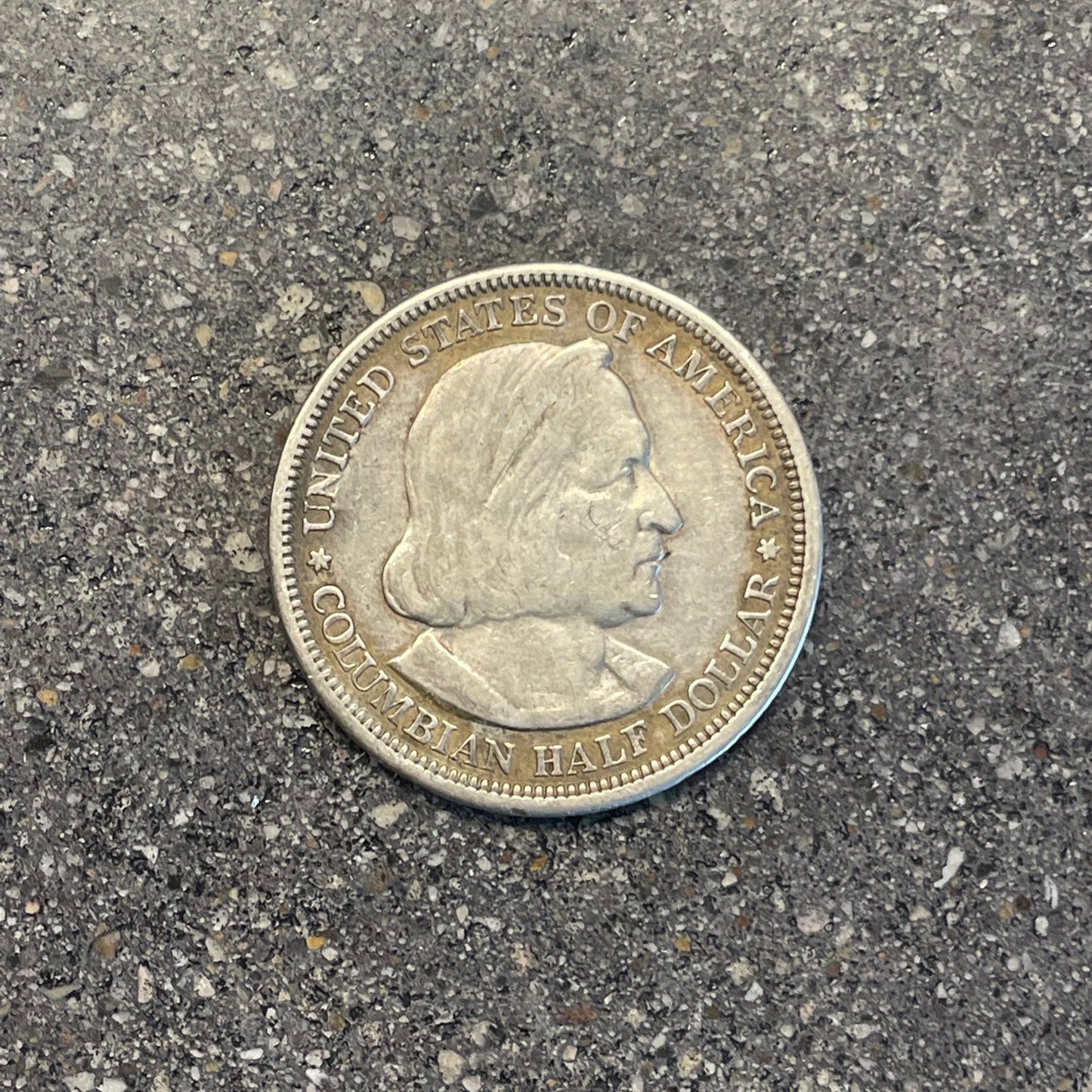 U.S. 1892-1893 Chicago Columbus Silver Half Dollar Coin front on a concrete background. - Mountainstruck Coin Jewelry