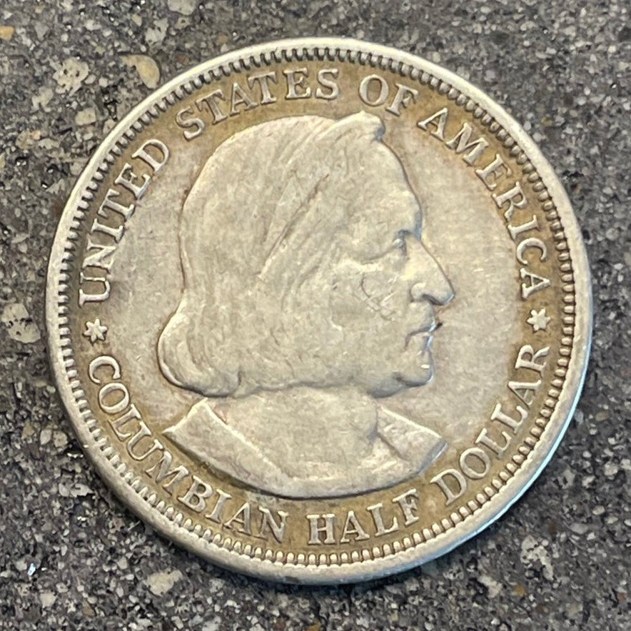 U.S. 1892-1893 Chicago Columbus Silver Half Dollar Coin front on a concrete background. - Mountainstruck Coin Jewelry