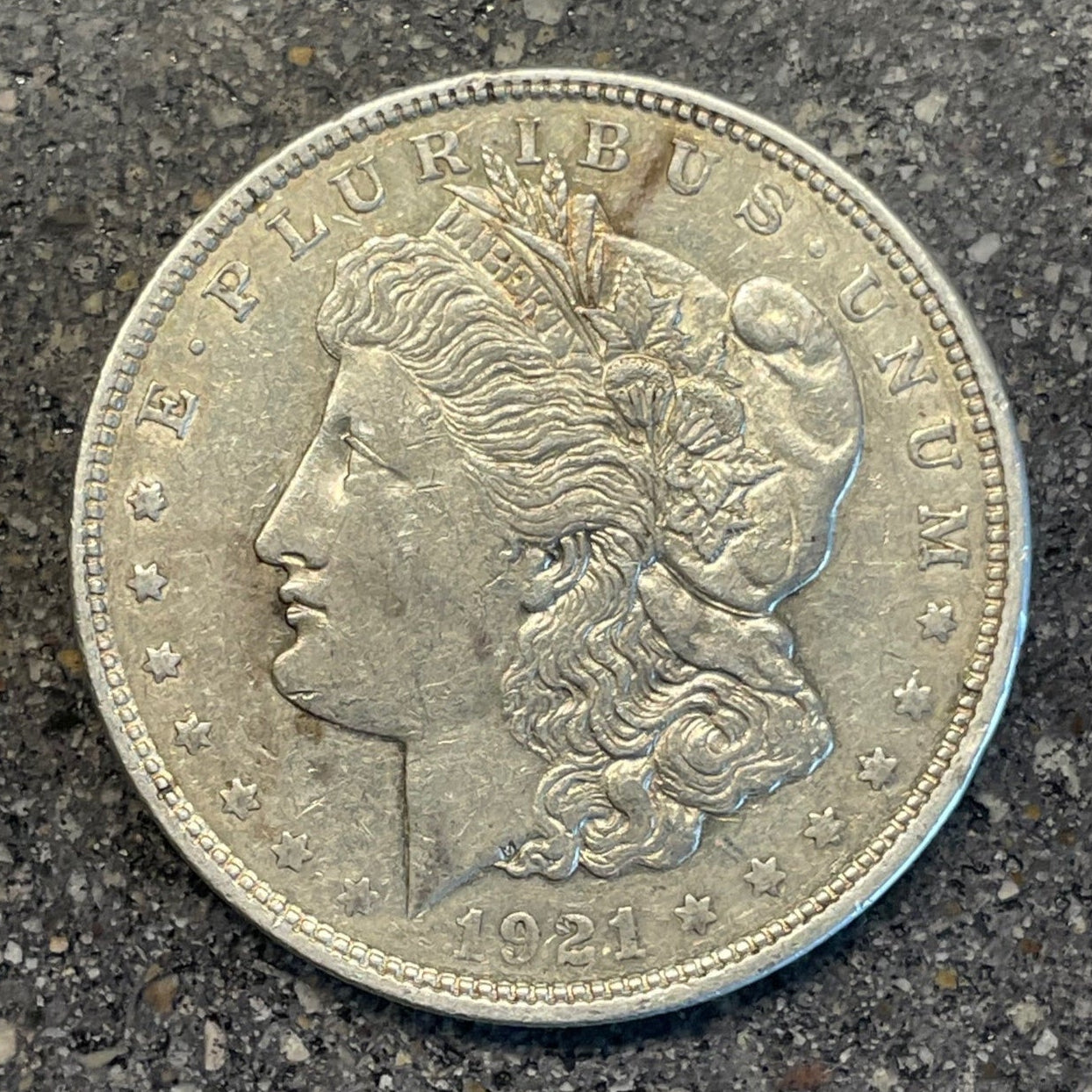 U.S. Morgan Dollar Silver Coin front on a concrete background. - Mountainstruck Coin Jewelry