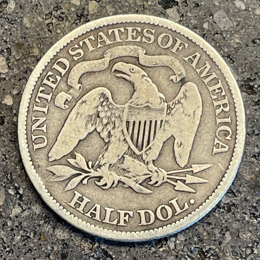 U.S. Seated Liberty Silver Half Dollar Coin back on a concrete background. - Mountainstruck Coin Jewelry