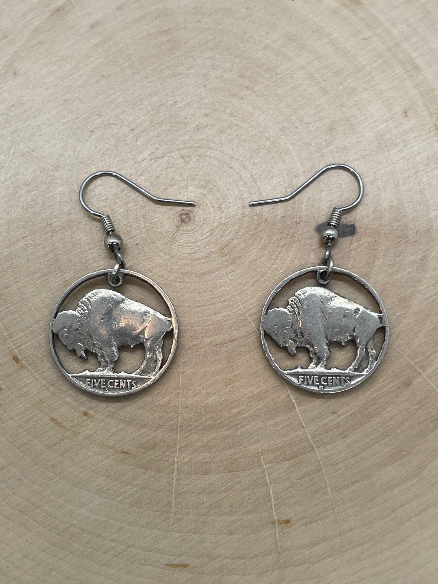 U.S. Buffalo Nickel Coin Earrings on a light wood round.
