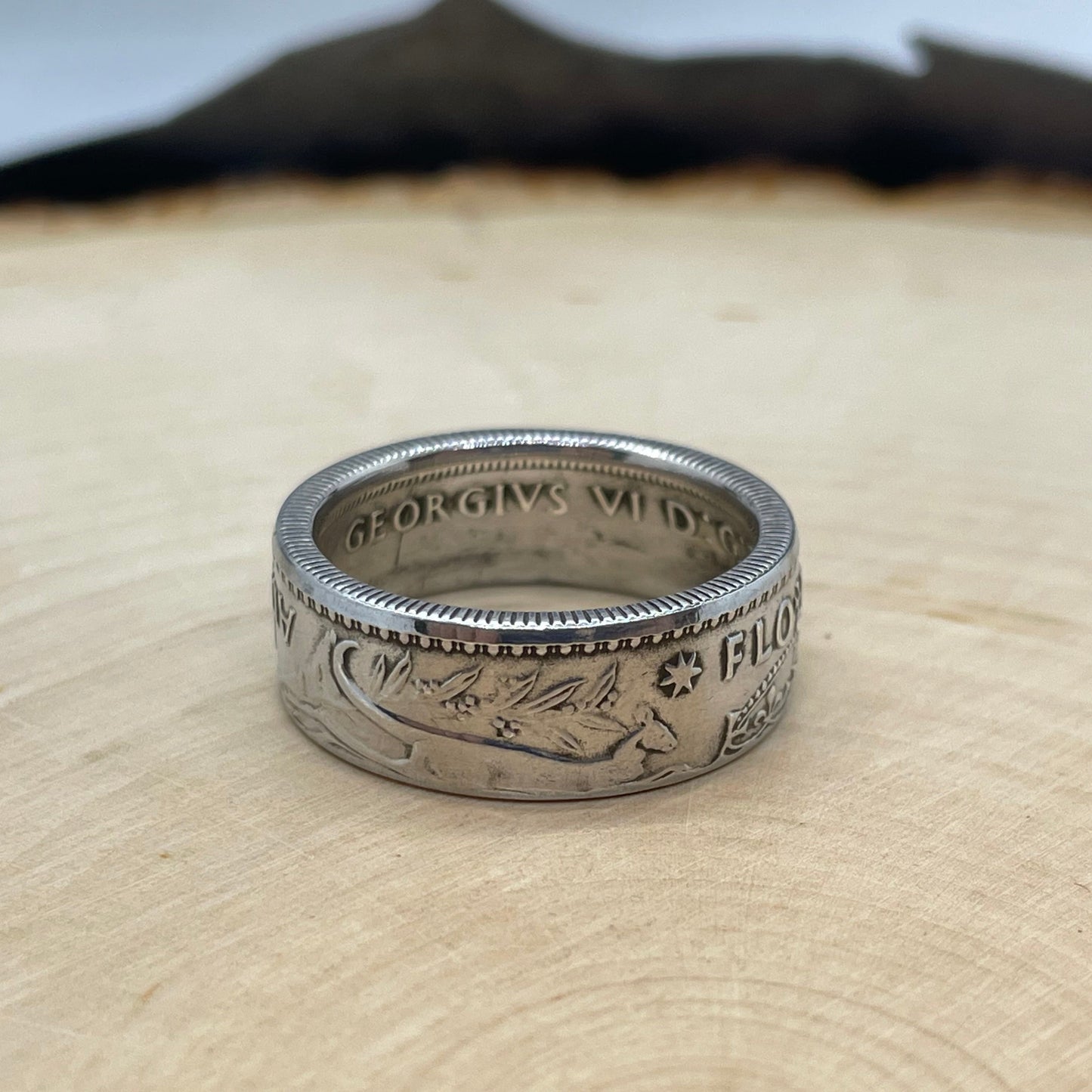Australia Silver Florin Coin Ring on a light wood background.