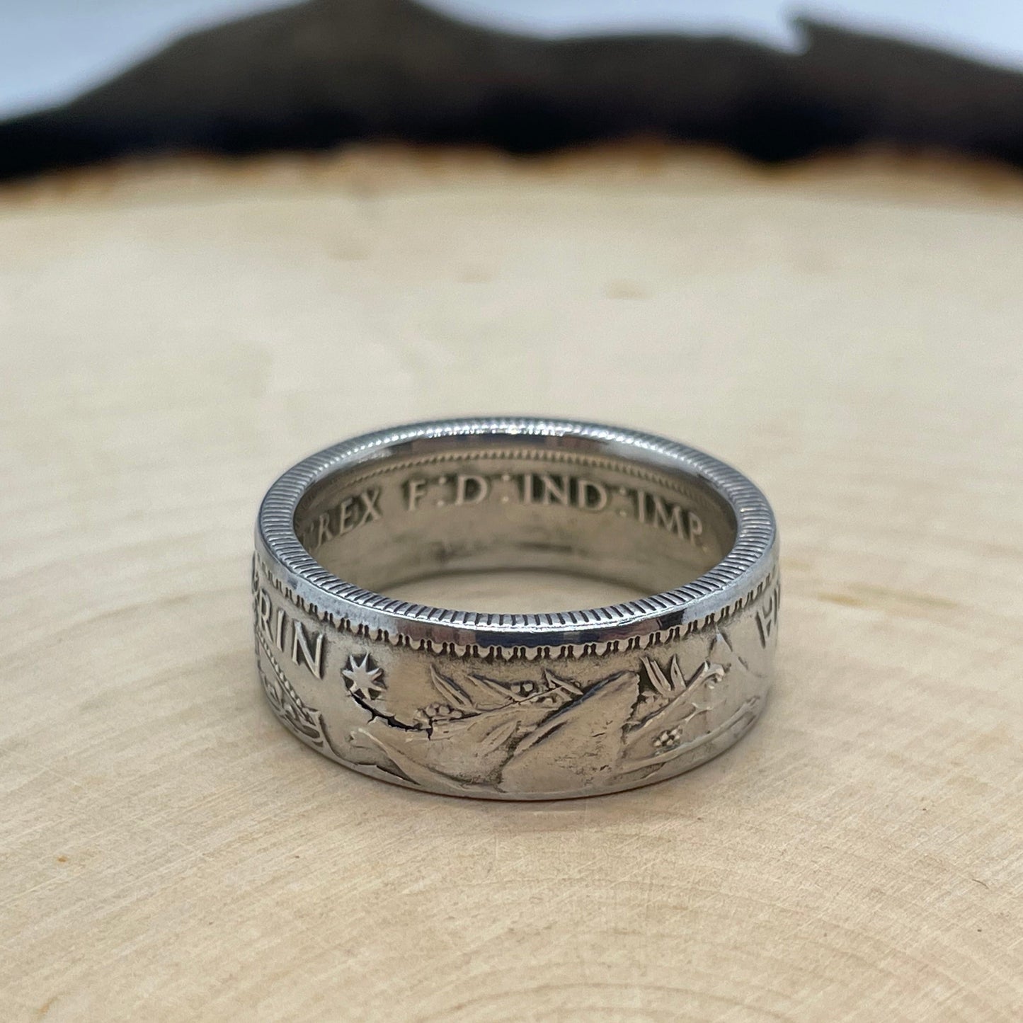 Australia Silver Florin Coin Ring on a light wood background.