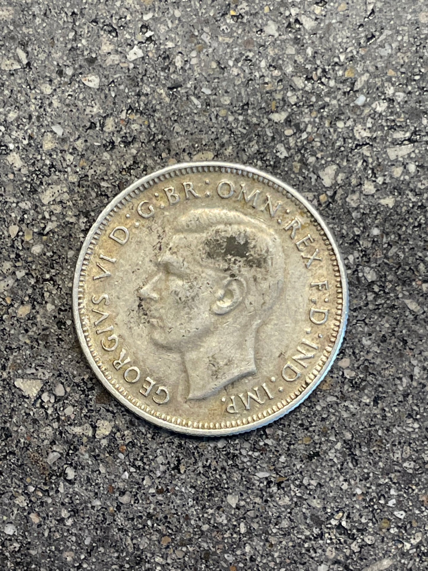 Australia Silver Florin front of coin on a concrete background.
