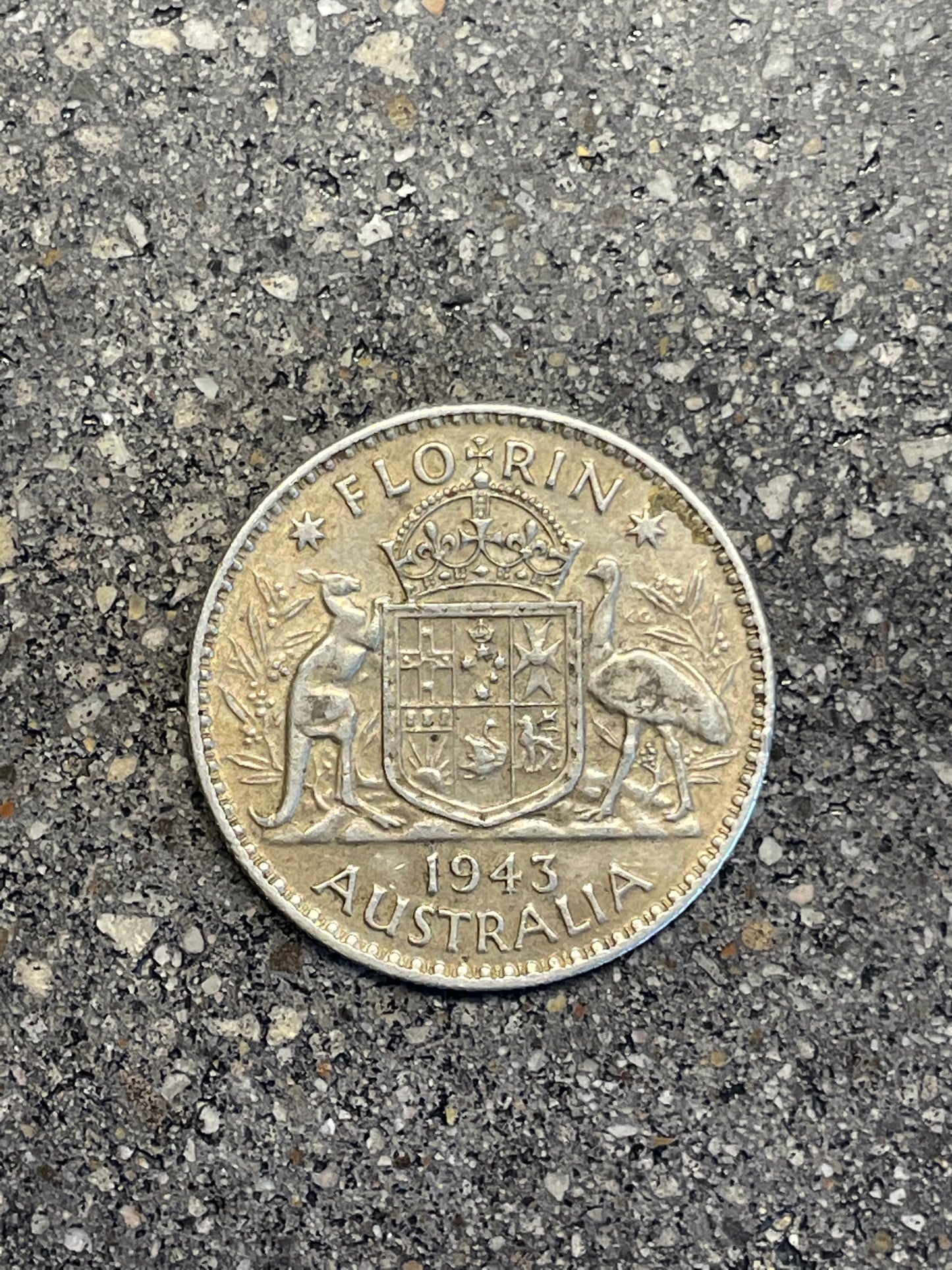 Australia Silver Florin back of coin on a concrete background.