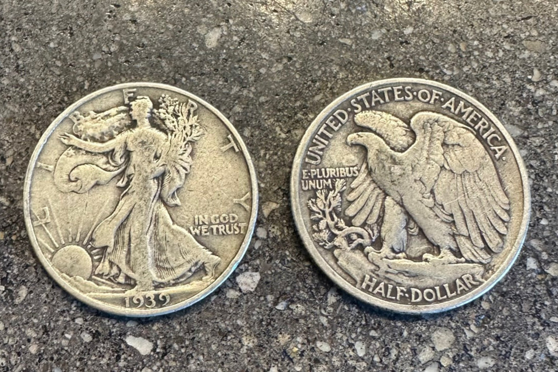 Walking Liberty Silver Half Dollar coin on a concrete background. Front of coin on the left side of image and back of coin on the right.