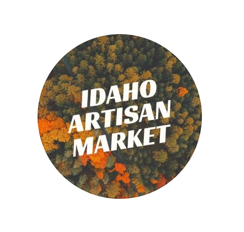 Round sticker with 'Idaho Artisan Market' text on a multicolored background. -Mountainstruck Coin Jewelry