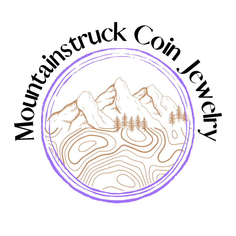 Logo of Mountainstruck Coin Jewelry with mountain and tree design. - Mountainstruck Coin Jewelry
