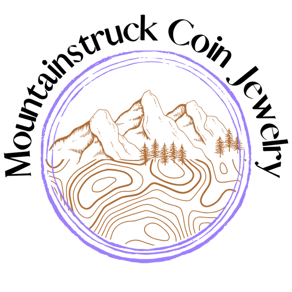 Mountainstruck Coin Jewelry wrapped around a bright purple circular border with orange-tan mountain outline inside and topo map below the mountains. - Mountainstruck Coin Jewelry 