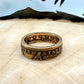 22k U.S. Gold Eagle $10 Coin Ring on a light wood round with a metal mountain background. - Mountainstruck Coin Jewelry