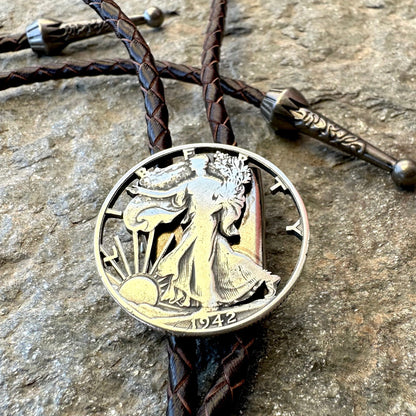 U.S. Walking Liberty Half Dollar Hand Cut Silver Coin Bolo Tie on a grey rock surface. - Mountainstruck Coin Jewelry