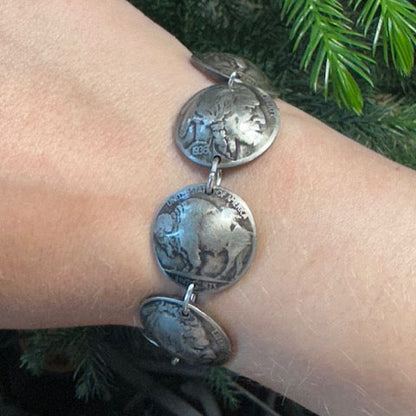 U.S. Buffalo Nickel Domed Coin Bracelet on a wrist in front of a pine tree. - Mountainstruck Coin Jewelry