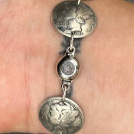 U.S. Mercury Dime Silver Coin Bracelet on a wrist showing magnetic clasp on a black background. - Mountainstruck Coin Jewelry
