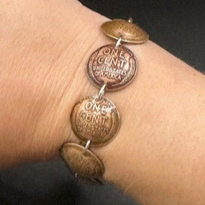 U.S. Wheat Penny Domed Coin Bracelet on a wrist in front of a black background. - Mountainstruck Coin Jewelry