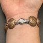 U.S. Wheat Penny Domed Coin Bracelet back on a wrist in front of a black background. - Mountainstruck Coin Jewelry