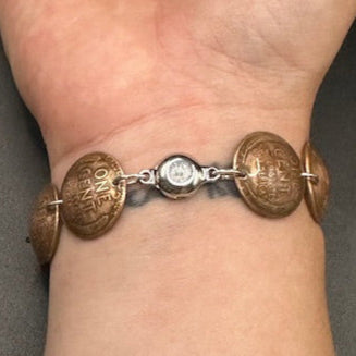 U.S. Wheat Penny Domed Coin Bracelet back on a wrist in front of a black background. - Mountainstruck Coin Jewelry