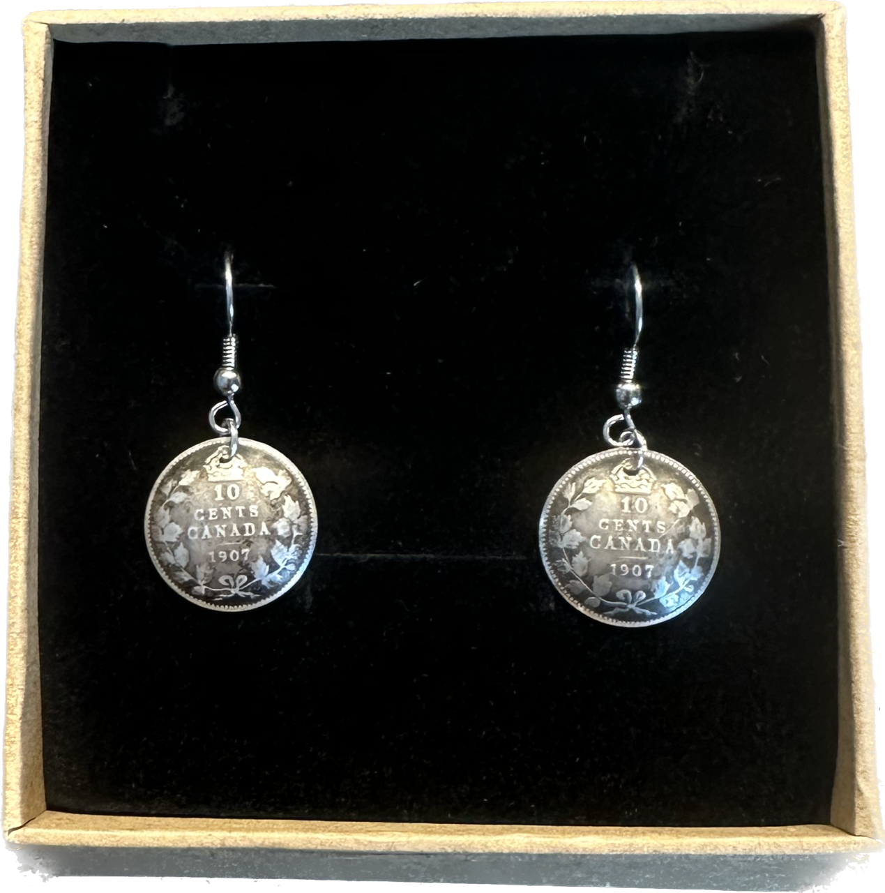Canada 10 Cents Silver Domed Earrings in a brown kraft box on a black velvet background. - Mountainstruck Coin Jewelry