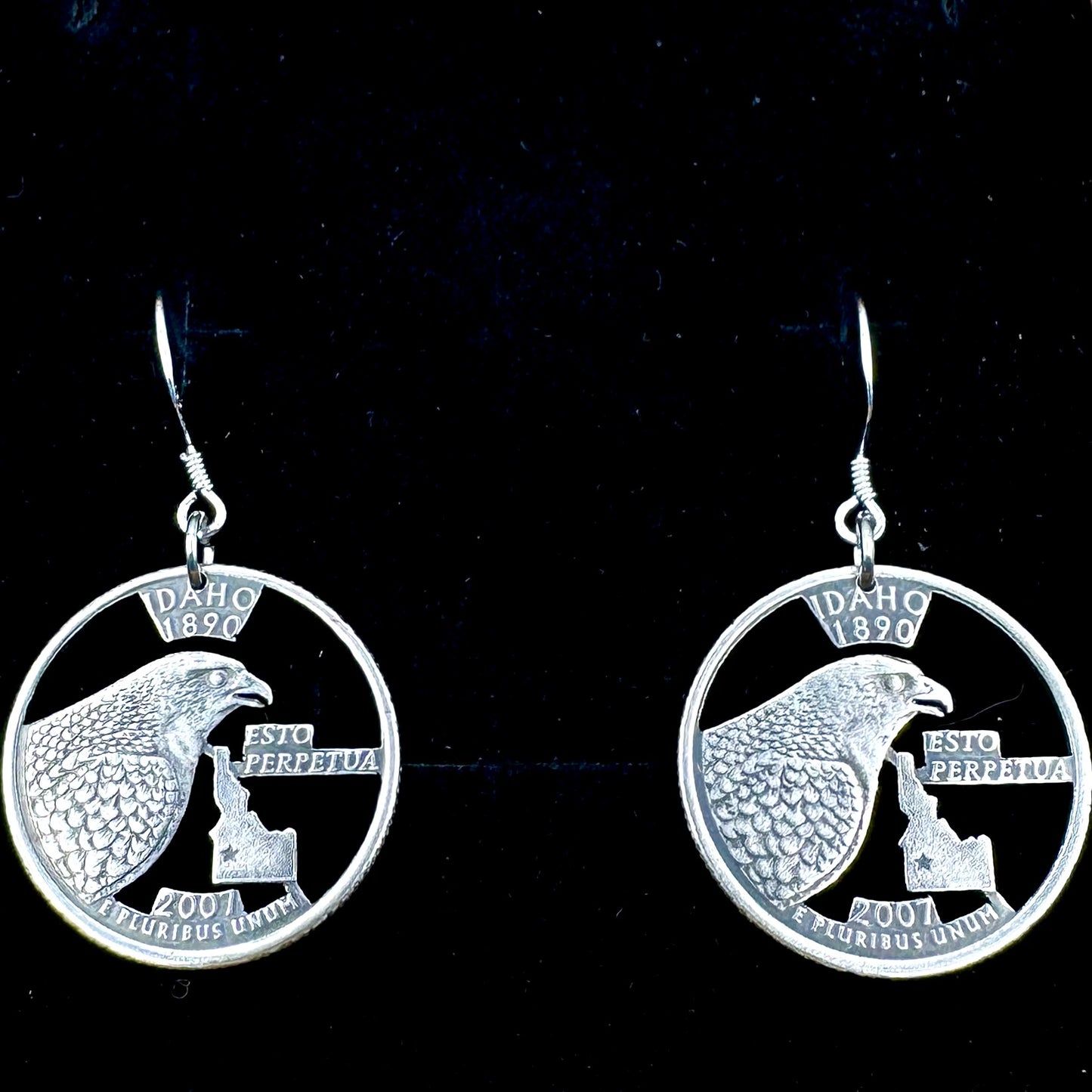 Idahome State Quarter Hand Cut Coin Earrings on a black velvet background. - Mountainstruck Coin Jewelry