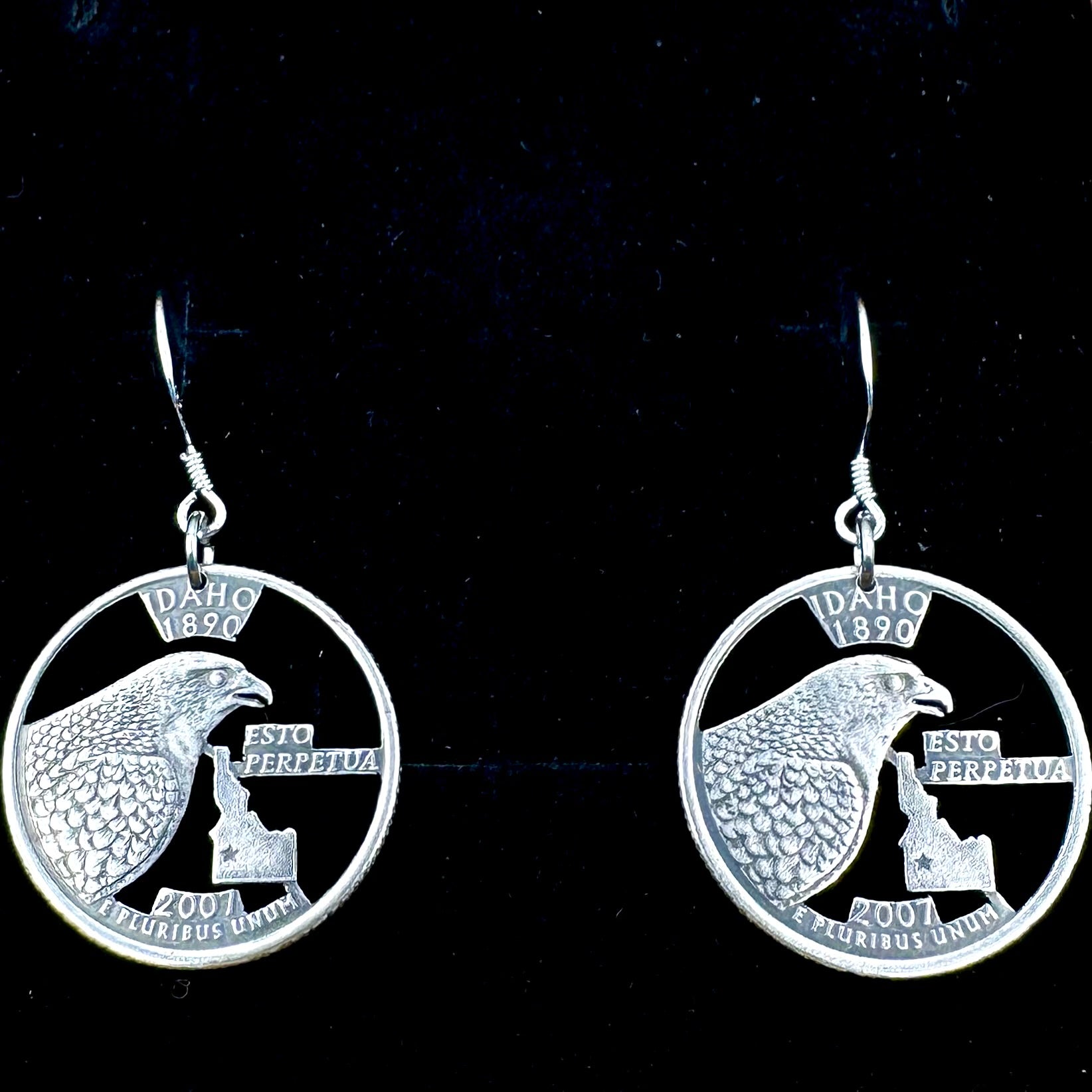 Idahome State Quarter Hand Cut Coin Earrings on a black velvet background. - Mountainstruck Coin Jewelry