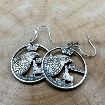 Idahome State Quarter Hand Cut Coin Earrings on a wood background. - Mountainstruck Coin Jewelry