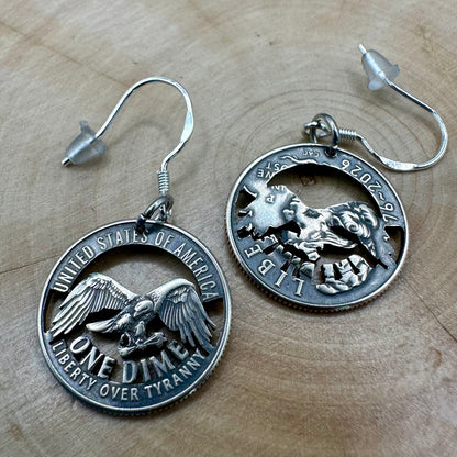 U.S. 2026 "Liberty over Tyranny" Dime Hand Cut Coin Earrings on a wood round. -Mountainstruck Coin Jewelry