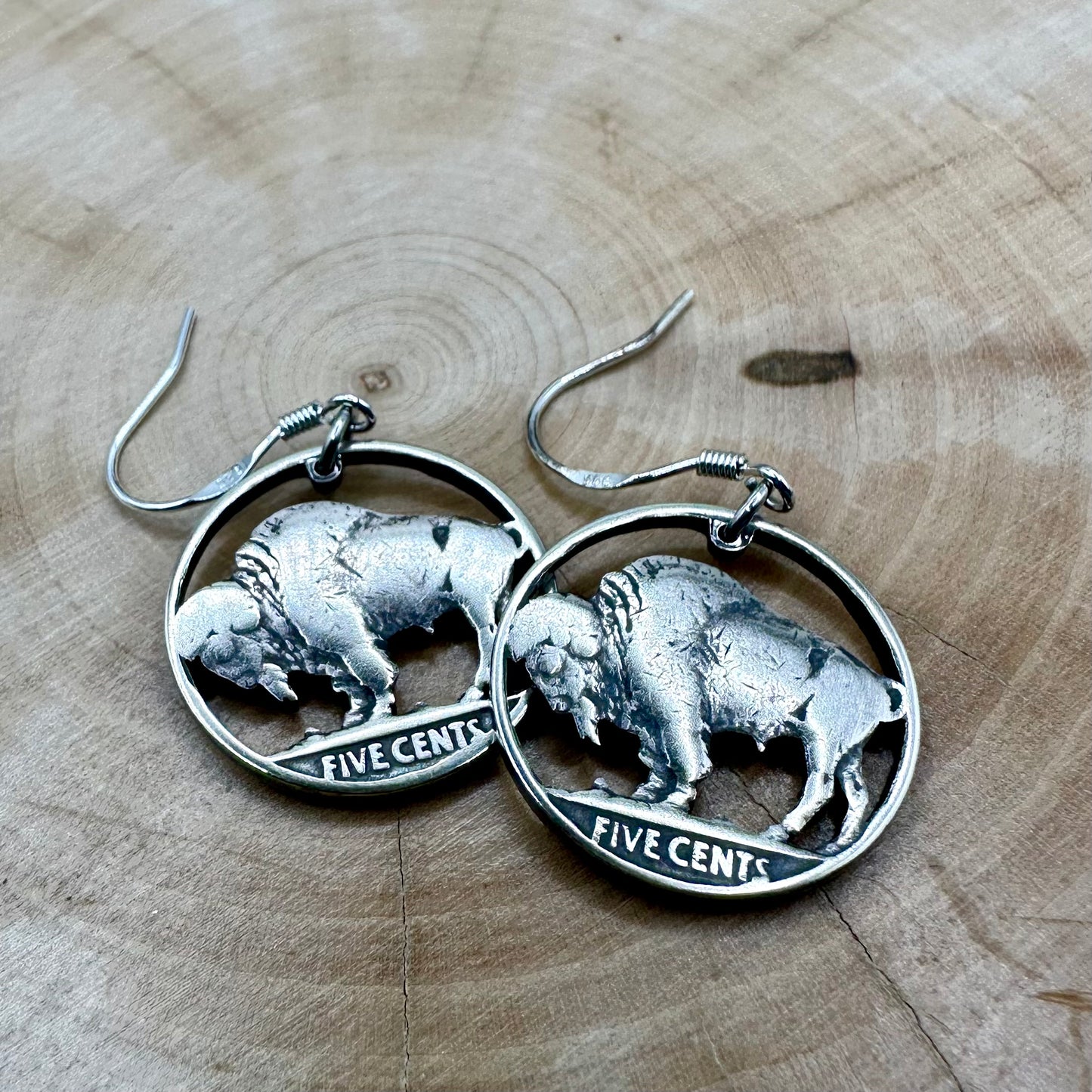 U.S. Buffalo Nickel Hand Cut Coin Earrings on a light wood round. - Mountainstruck Coin Jewelry