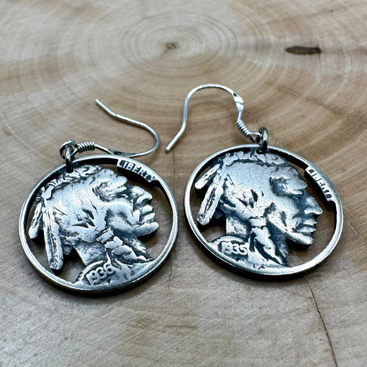 U.S. Buffalo Nickel Hand Cut Coin Earrings (Front) on a light wood round. - Mountainstruck Coin Jewelry