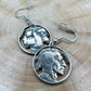 U.S. Buffalo Nickel Hand Cut Coin Earrings (Front) on a light wood round. - Mountainstruck Coin Jewelry