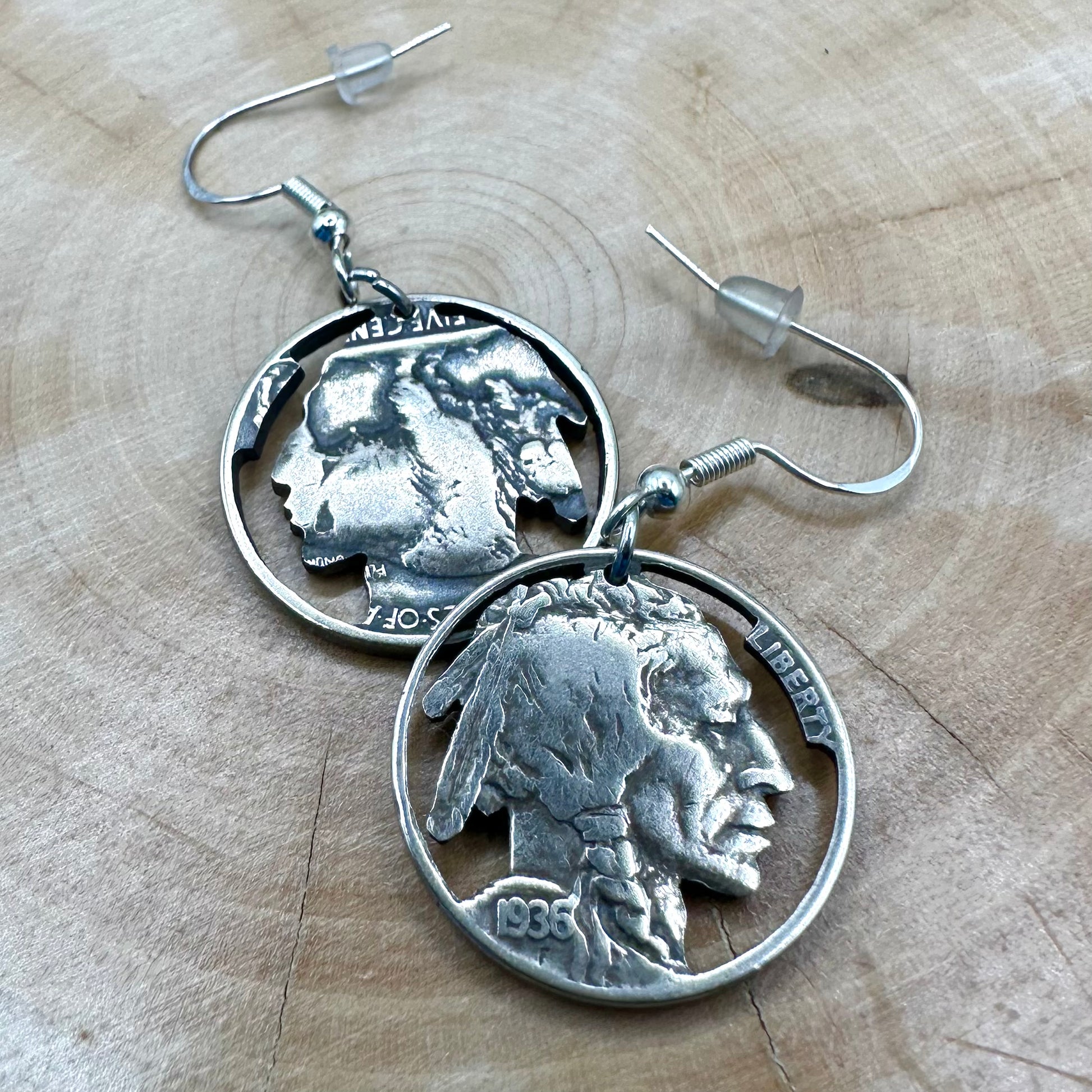 U.S. Buffalo Nickel Hand Cut Coin Earrings (Front) on a light wood round. - Mountainstruck Coin Jewelry