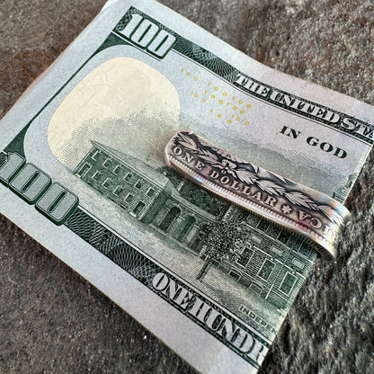 U.S. Morgan Dollar Silver Coin Money Clip holding money on a textured rock background.
- Mountainstruck Coin Jewelry