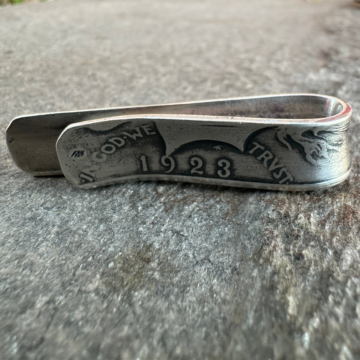 U.S. Peace Dollar Silver Coin Money Clip on a textured rock background.
- Mountainstruck Coin Jewelry