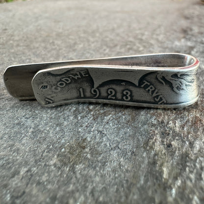 U.S. Peace Dollar Silver Coin Money Clip on a textured rock background.
- Mountainstruck Coin Jewelry