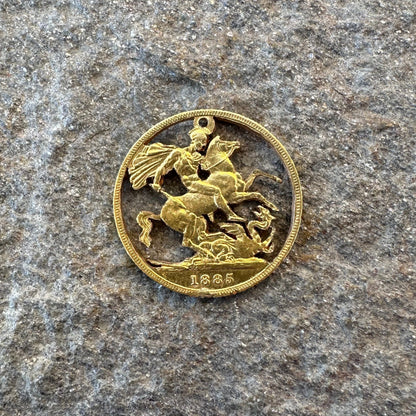 22k Solid Gold UK Gold Sovereign hand cut coin necklace on a grey rock background. - Mountainstruck Coin Jewelry