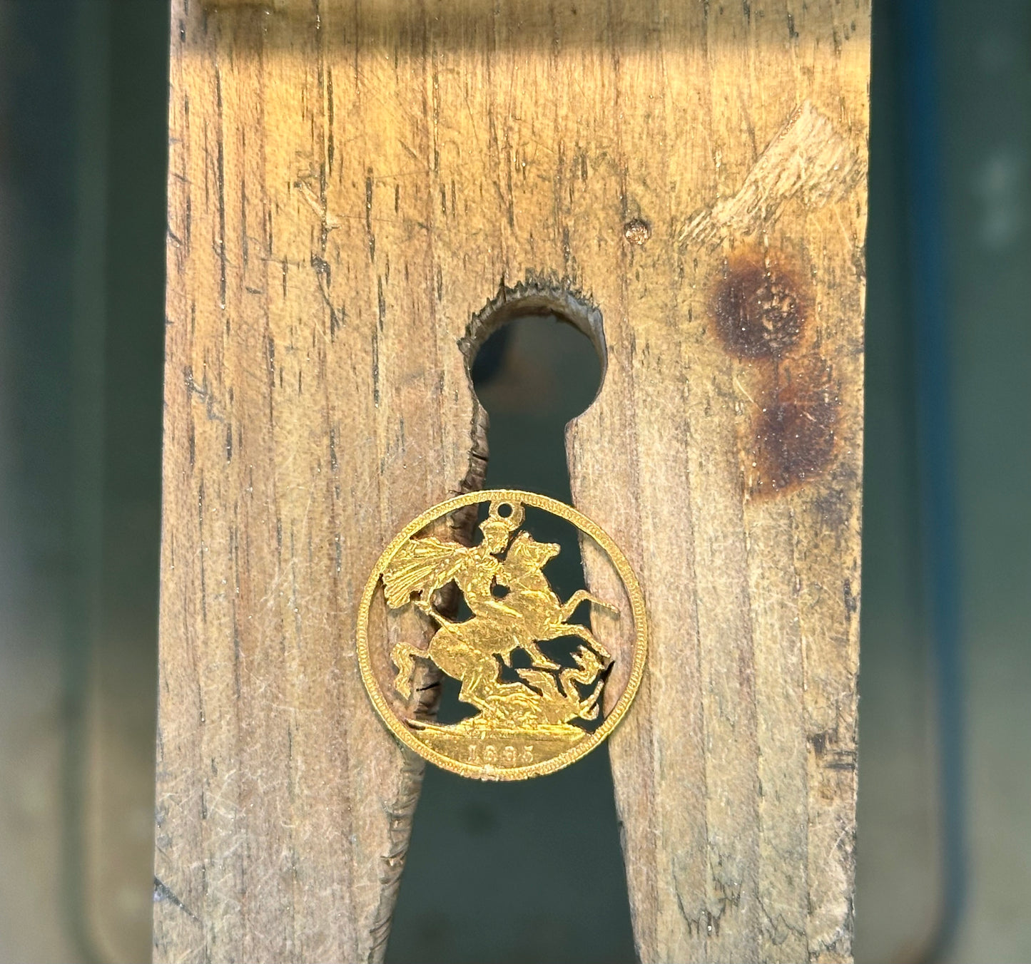 22k Solid Gold UK Gold Sovereign hand cut coin necklace on a wood background. - Mountainstruck Coin Jewelry