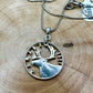 Caribou Canada Silver 25 Cent Hand Cut Coin Necklace on a light wood round. - Mountainstruck Coin Jewelry
