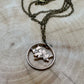 Canada Maple Leaf Penny Hand Cut Coin Necklace back with bronze chain on a light wood round. - Mountainstruck Coin Jewelry