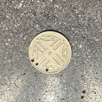Columbia 200 Pesos Quimbaya Spindle Wheel coin (front) on a concrete background. - Mountainstruck Coin Jewelry