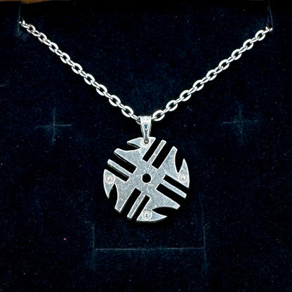 Columbia 200 Pesos Quimbaya Spindle Wheel Hand Cut Coin Necklace with a stainless chain on a black velvet background. - Mountainstruck Coin Jewelry