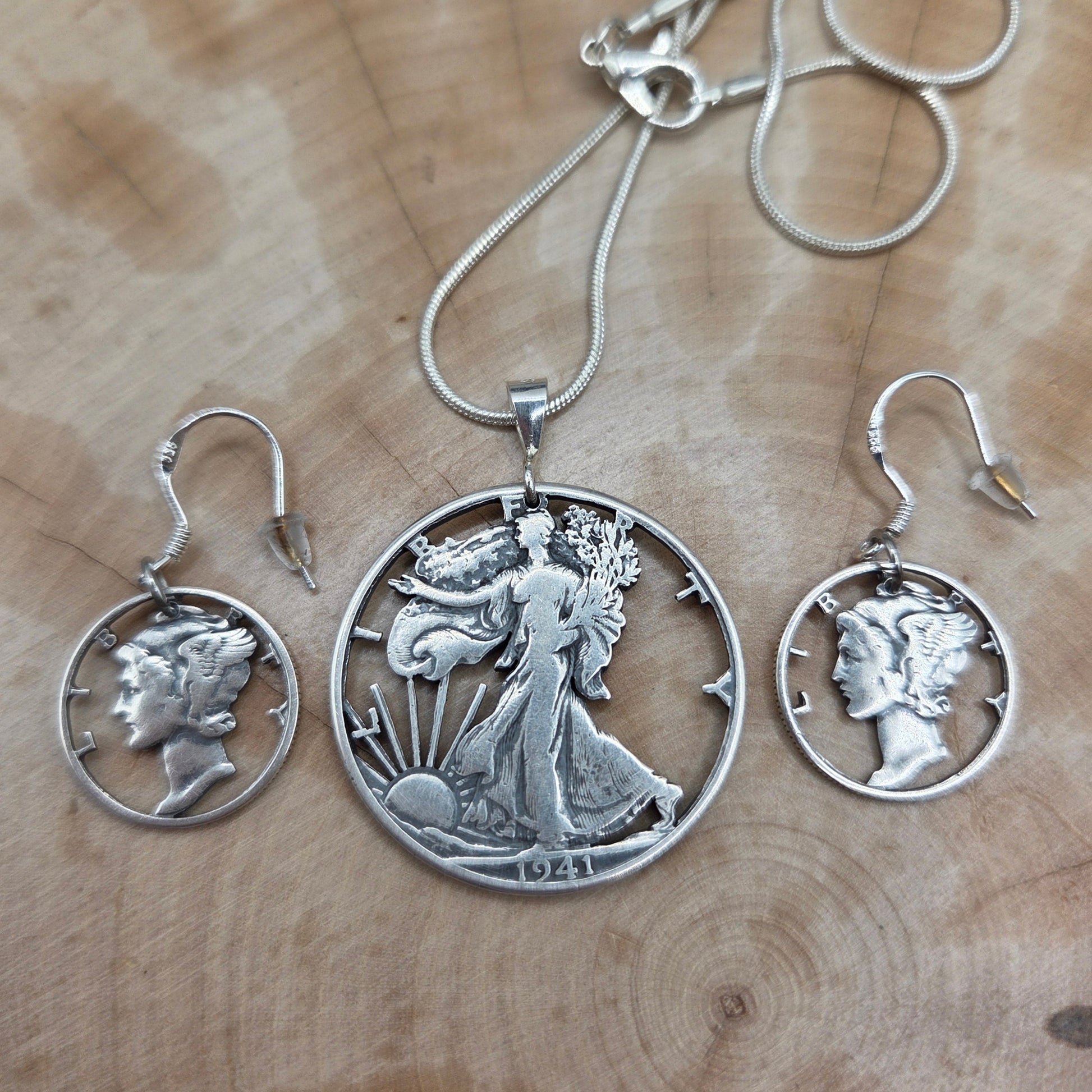 U.S. Lady Liberty Hand Cut Silver Coin Collection (snake chain) on a wood background- Mountainstruck Coin Jewelry