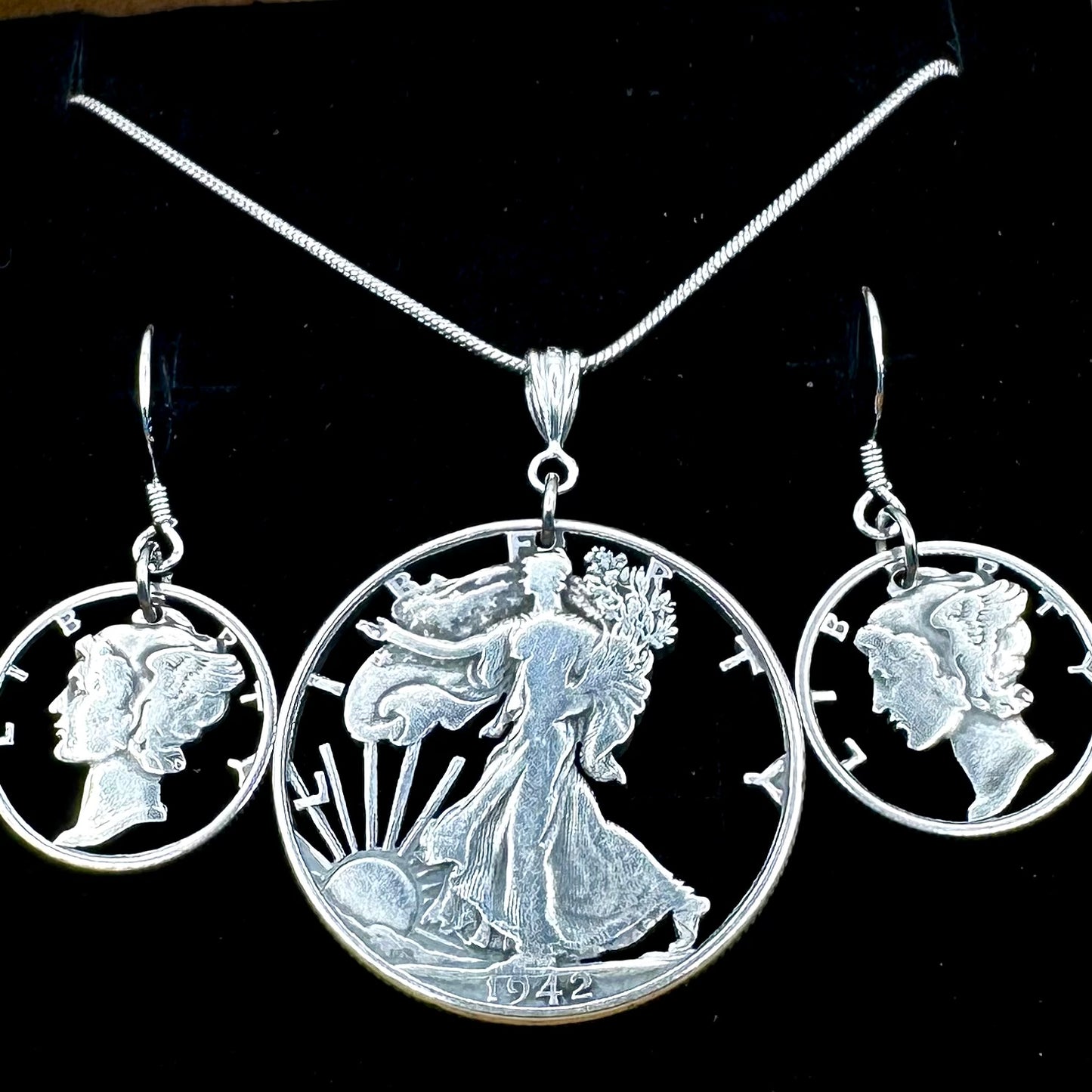 U.S. Lady Liberty Hand Cut Silver Coin Collection (snake chain) on a black velvet background- Mountainstruck Coin Jewelry