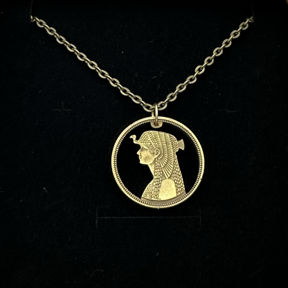 Cleopatra Egypt 50 Qirsh/Piastres Hand Cut Coin Necklace in a brown kraft box on a black velvet background. - Mountainstruck Coin Jewelry