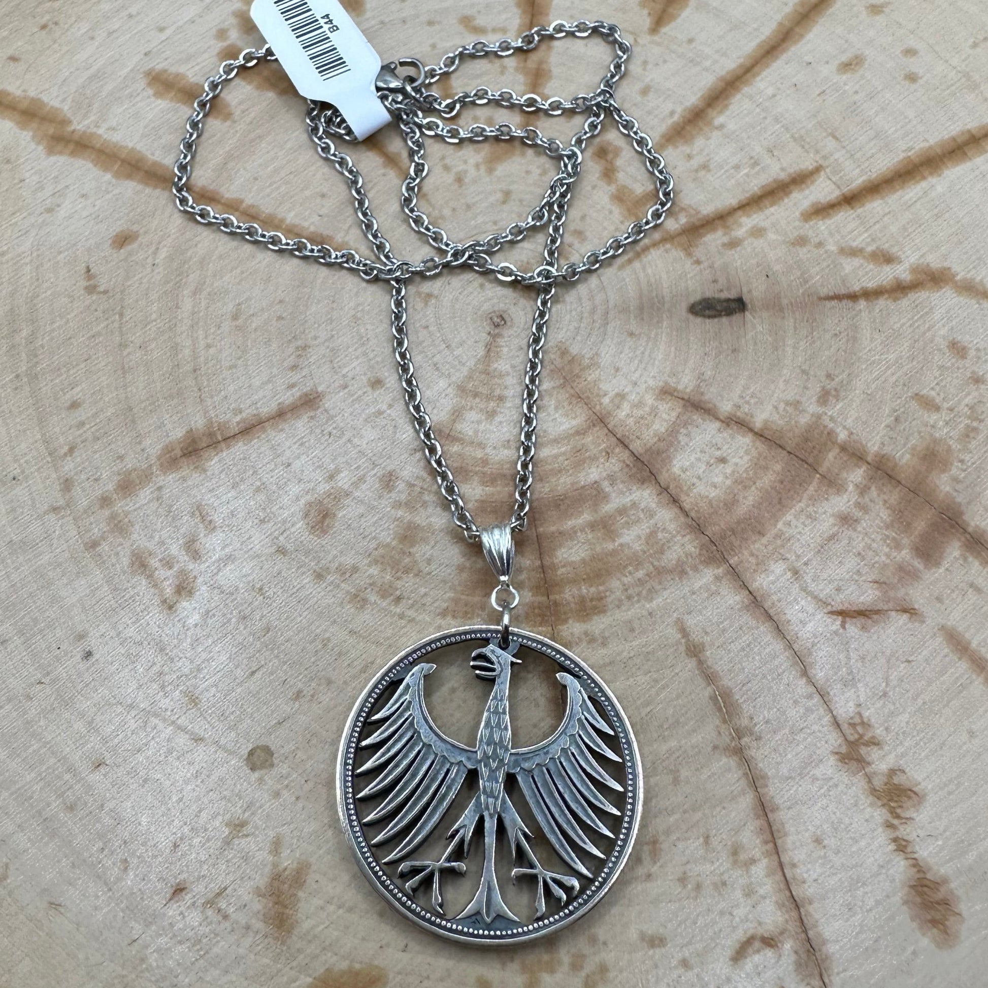 Germany Eagle 5 Mark Hand Cut Silver Coin Necklace on wood background. - Mountainstruck Coin Jewelry