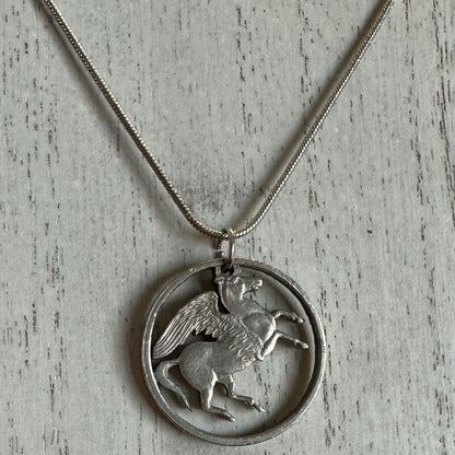 Greece Pegasus 5 Drachmai Hand Cut Coin Necklace with snake chain on a white wood background. - Mountainstruck Coin Jewelry
